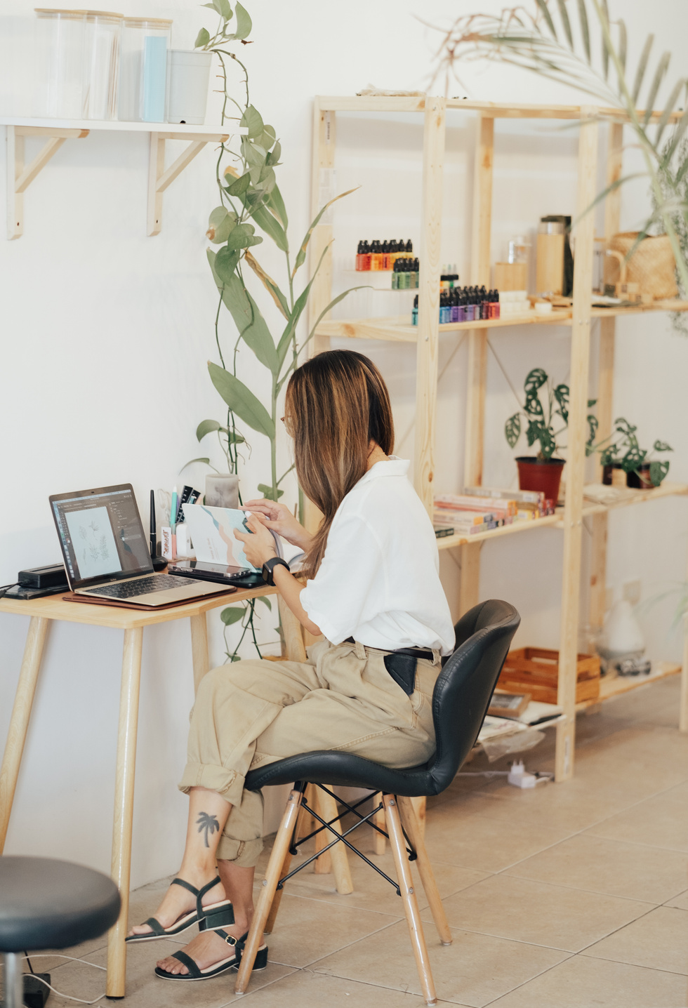 Female Designer Working with Laptop in Studio